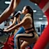 woman-drinks-water-on-a-stationary-bike-in-gym-5YEDLJY-min.jpg